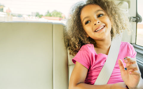 Child in back seat with seat belt on