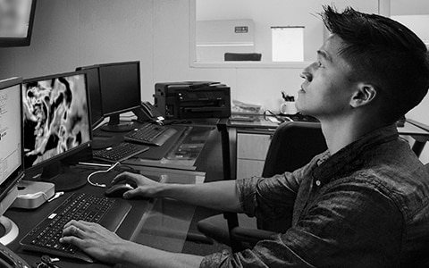 Man at a desk monitoring progress of a storm