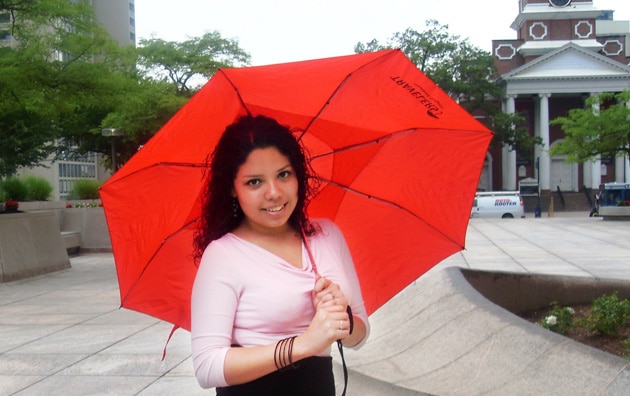Teresa Frausto holding Travelers umbrella