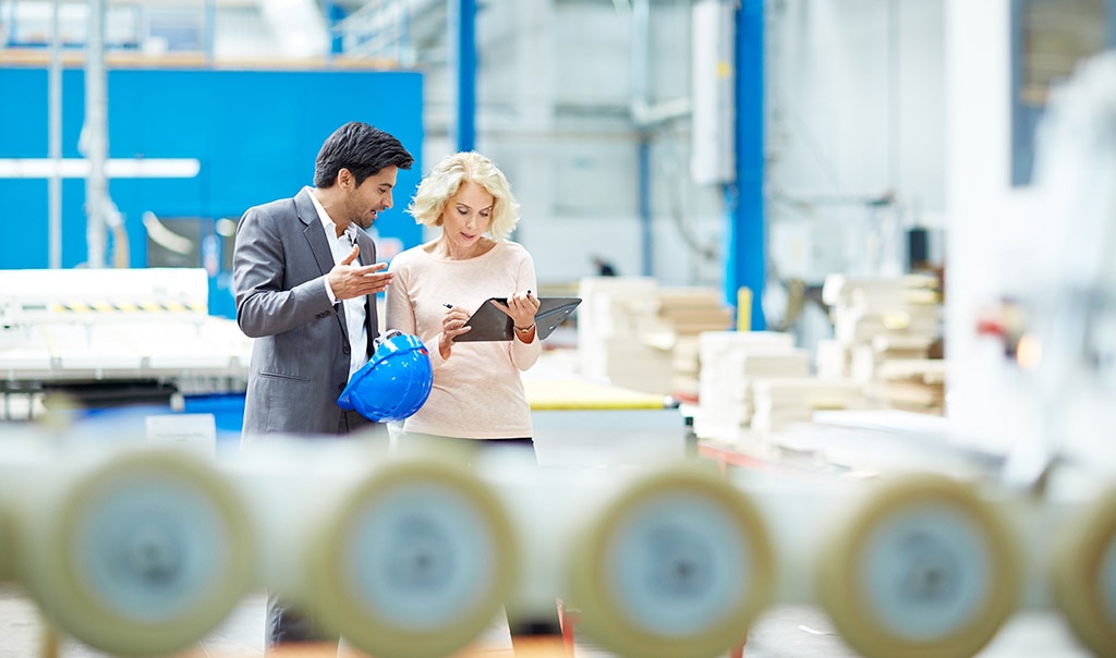 Man and women reviewing digital checklist