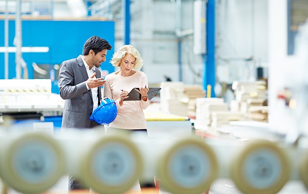 Man and women reviewing digital checklist