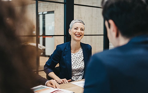 Woman at desk smiling