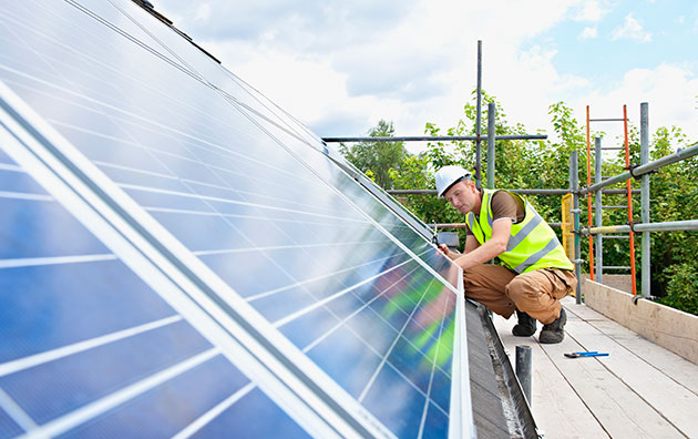 energy professional installing solar panels