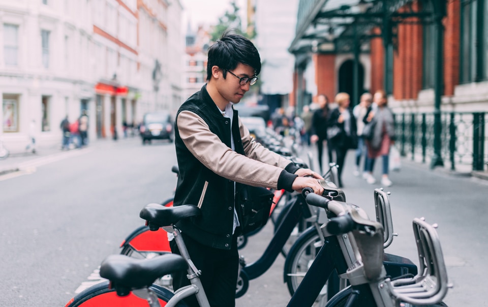 Person parking smart bike, as part of smart city transportation