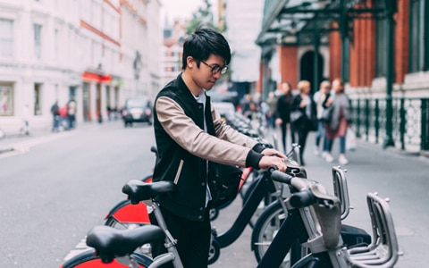 person using smart technology to lock bike on street