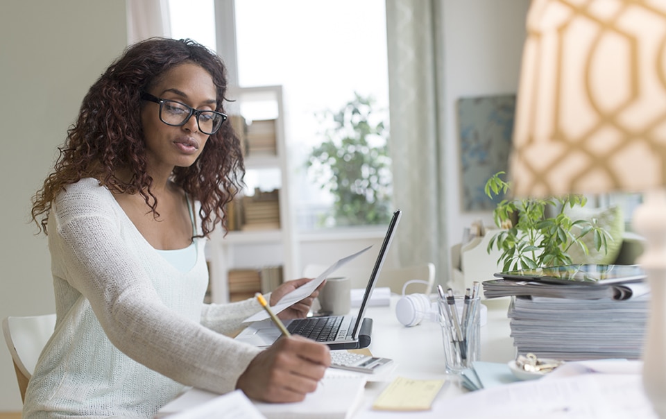 Woman sitting at computer in home office