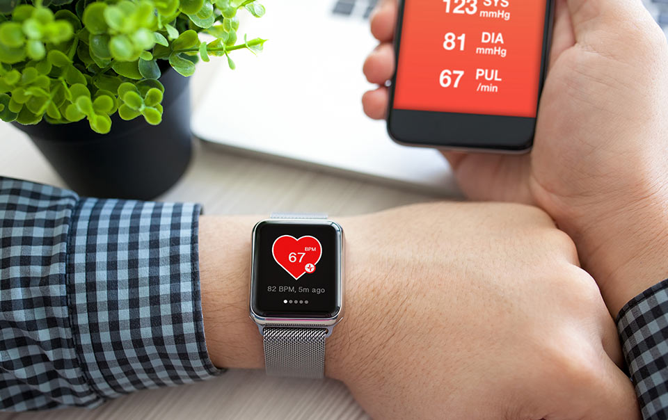 Small business worker checking health tracker at work