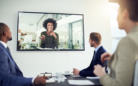 tech company employees meeting with remote worker