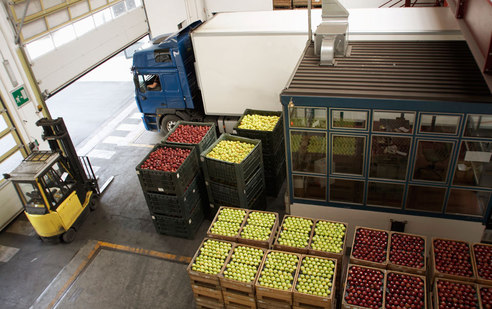 Truck driving next to open crates of fruit