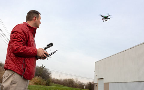 person using drone over building