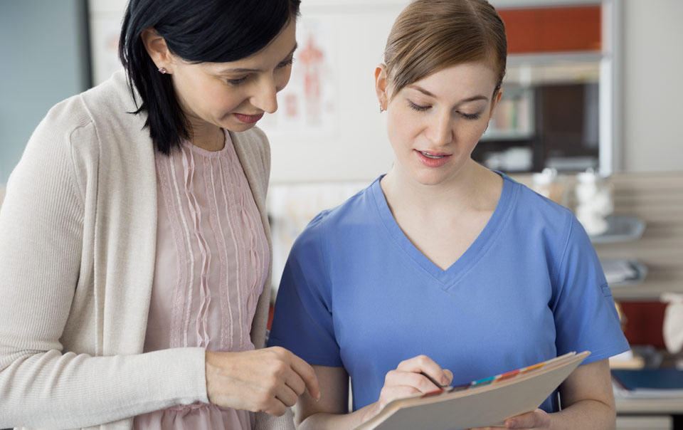Employee and nurse reviewing medical costs