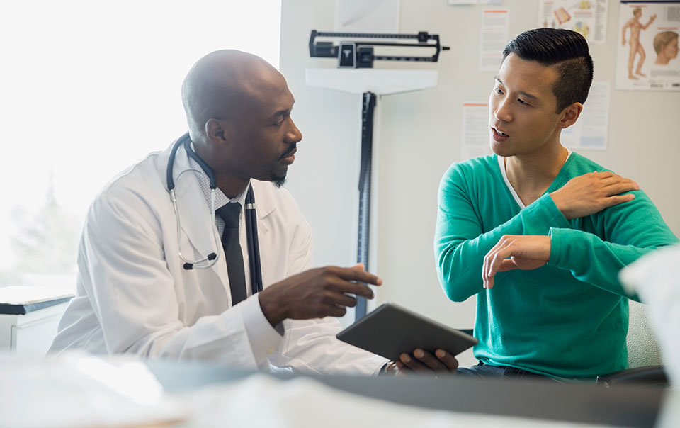 Doctor examining patient with chronic pain