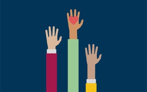 Three hands held up, one with a heart in the middle