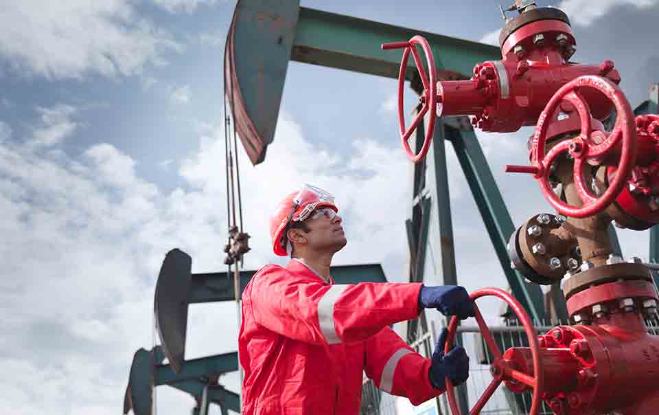 oil and gas worker handling equipment