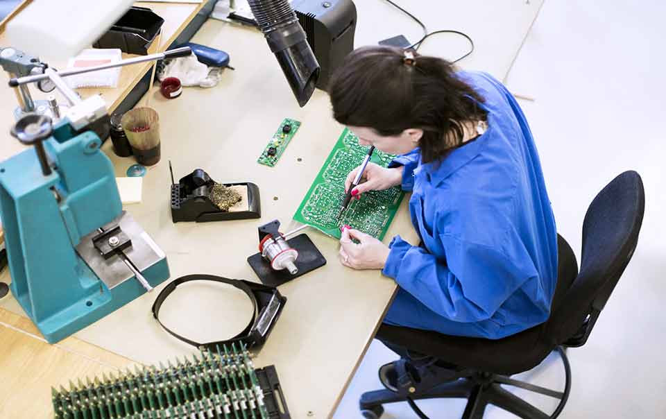 Woman studying counterfeit parts