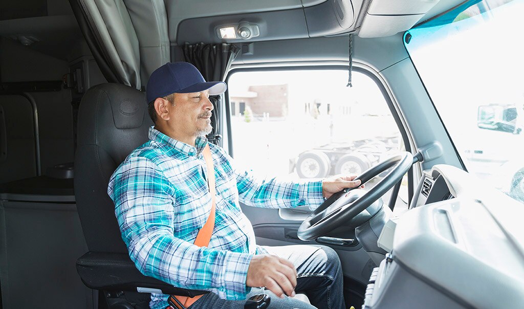 Fleet safety program - photo of a truck driver at the wheel of a large commercial vehicle