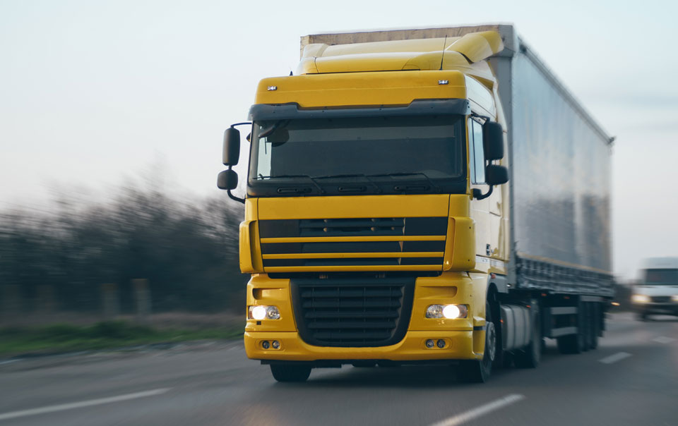 Truck carrying cargo driving on highway