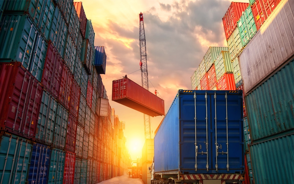 cargo yard with crane loading and unloading cargo containers, Travelers Special Investigations Group Marks 15 Years