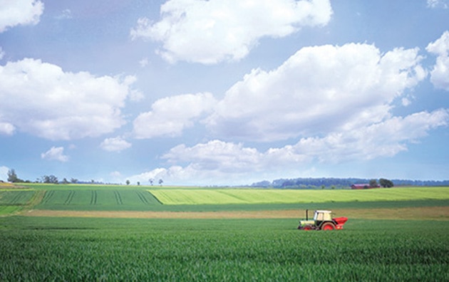 Landscape view of farm and tractor trailer