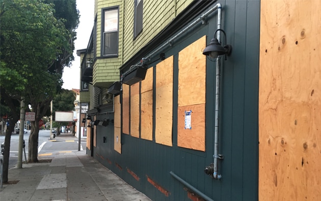 boarded up business fronts with plywood