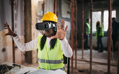 Construction worker wearing virtual reality glasses