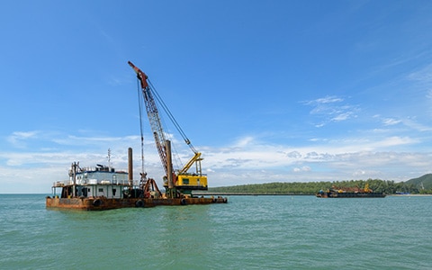 Crane on a barge o fa marine construction site