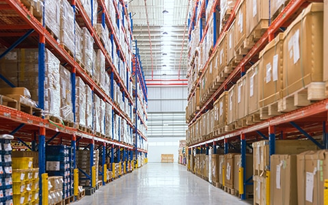 Warehouse aisle with full shelves