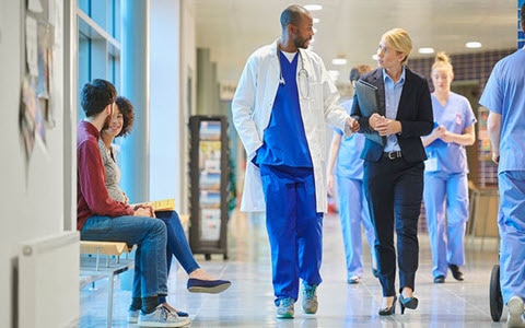 Doctor and administrator walking through a hospital