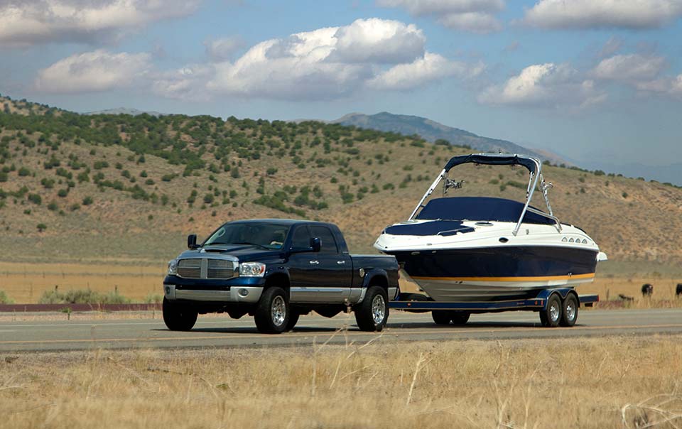 Black truck towing a boat