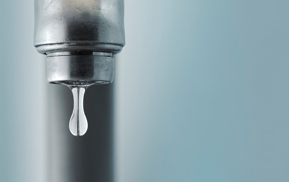 Close-up of a dripping faucet