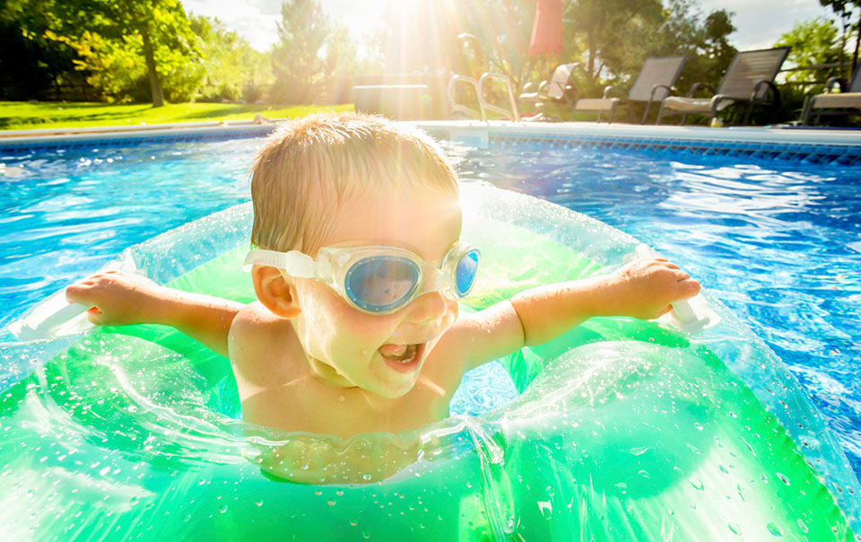 Boy swimming and practicing pool safety