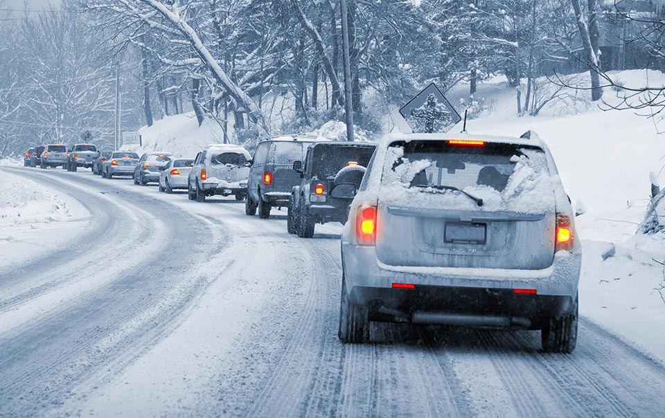 Line of cars driving in snow