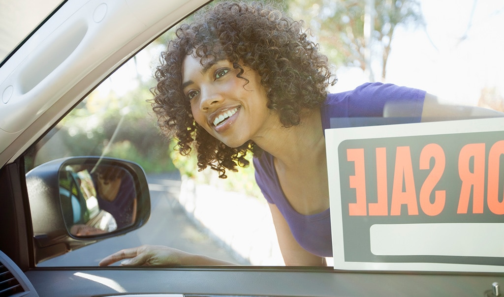 woman looking in car window with 