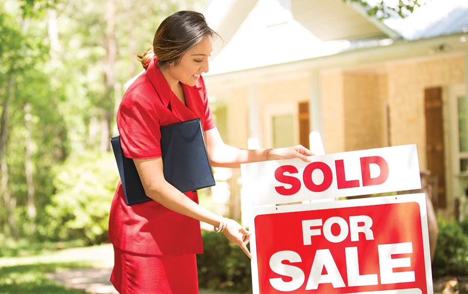 real estate agent setts out for sale sign, 10 Reasons Why You May Need a Real Estate Agent