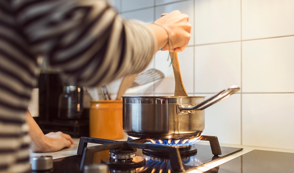 Towel catches on fire next to pot on stove