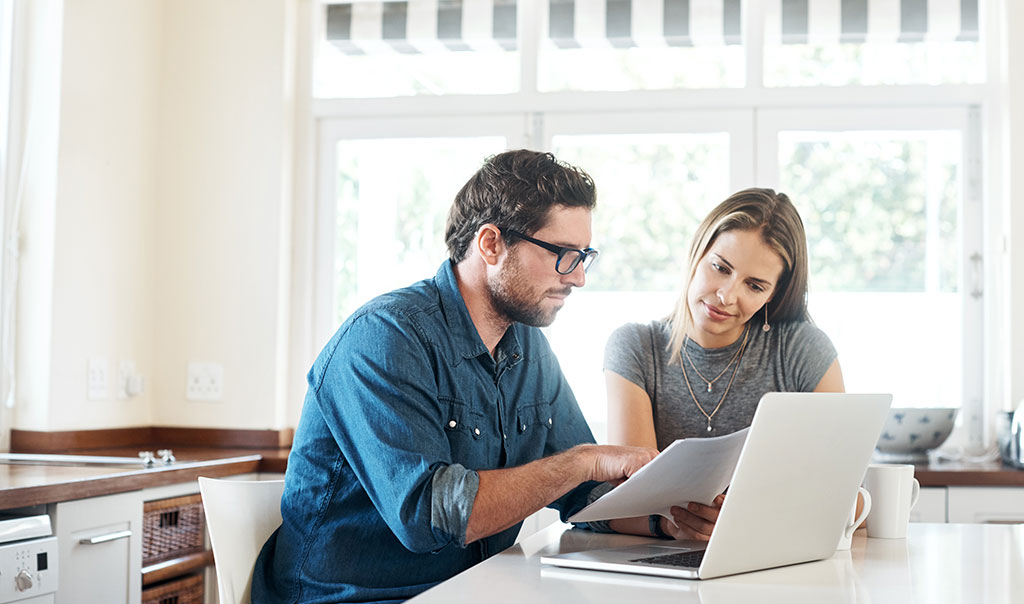 man and woman looking at computer