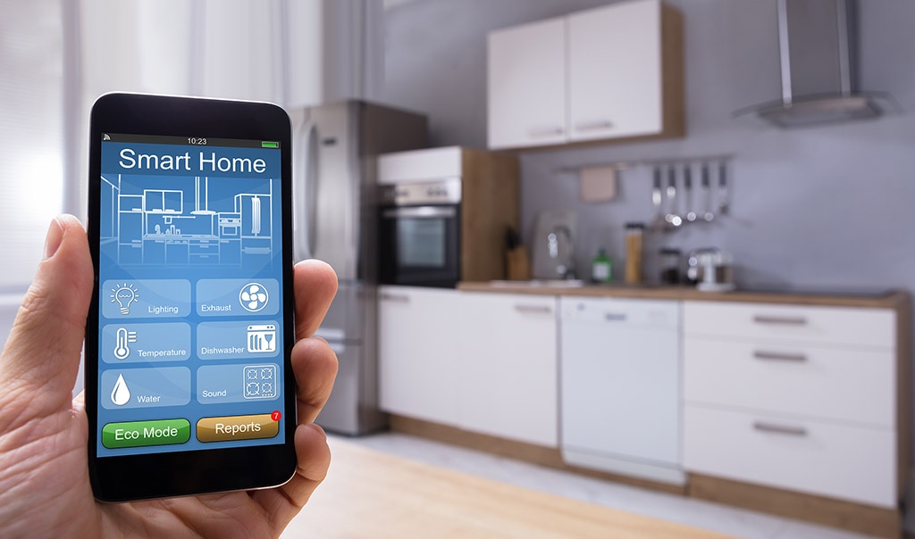 hand holding a Smart Home Leak Detection Device to Help Avoid Water Damage