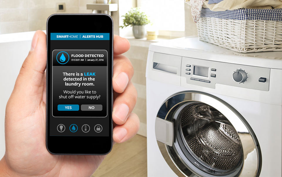 Water sensor alert appearing on a smartphone in front of a washer