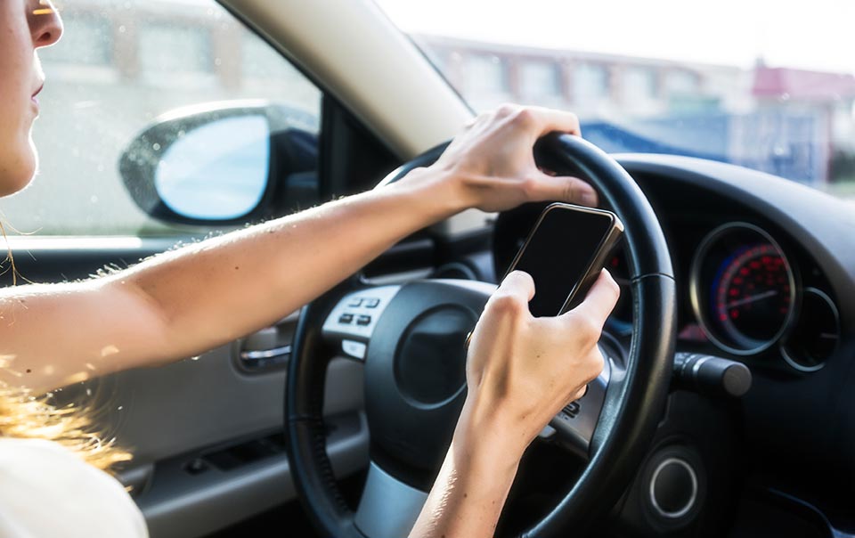 Teenager texting behind the wheel