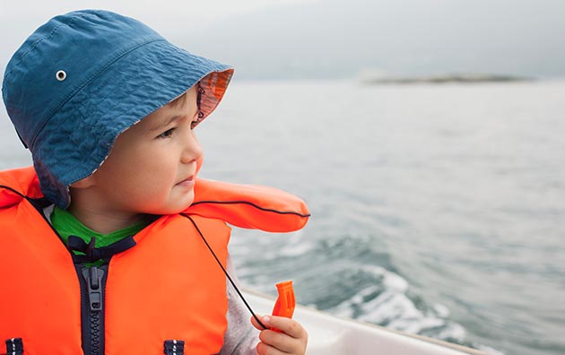Boy looking out on to the water