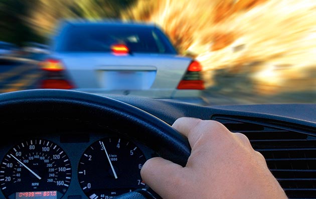 Person driving with another car on the road