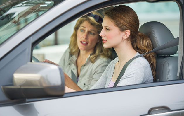 Mother teaching teenage daughter how to drive