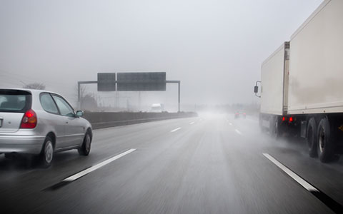 Cars driving in rain and wind