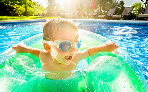 Child swimming safely in a pool