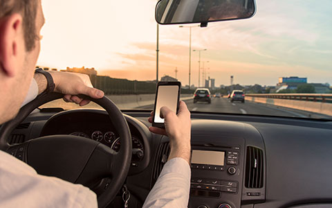 Woman driving distracted behind the wheel