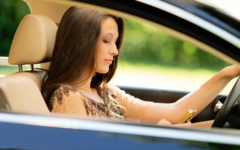 Woman distracted while driving by phone