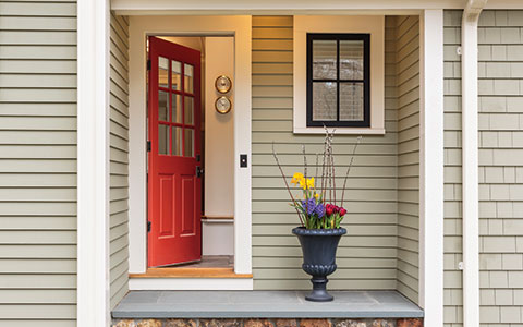Image of home with the front door ajar. Does Homeowners Insurance Cover Theft?