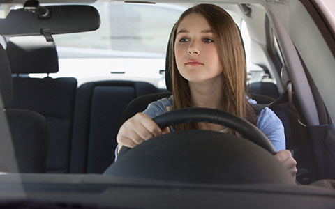 Teen driver behind the wheel of a car