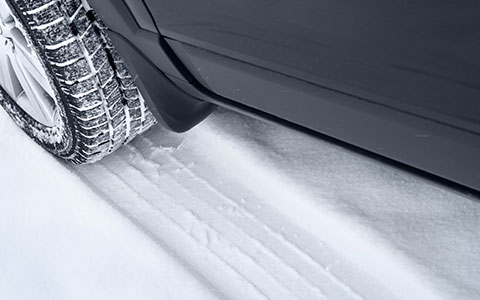 Close up of tire treads on snowy road
