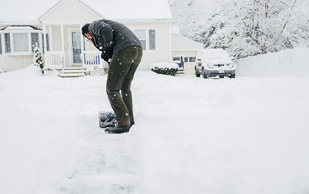 Person shoveling their driveway after a snow storm